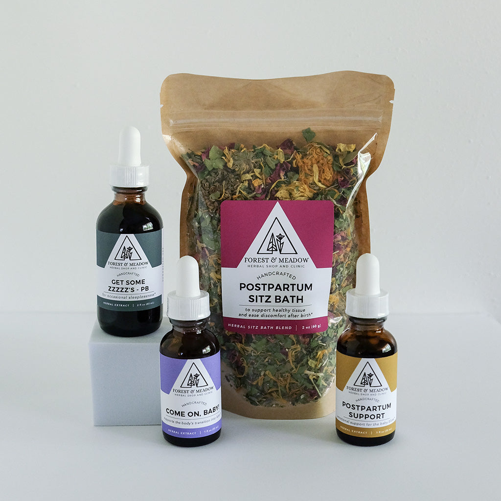 Group photo of Forest & Meadow products available at Birth Order. Including Get Some Zzzz's Tincture, Come on Baby & Postpartum Support Herbal Extracts, & pouch of natural Sitz Bath